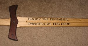 Wooden sword inscribed with a camper's name